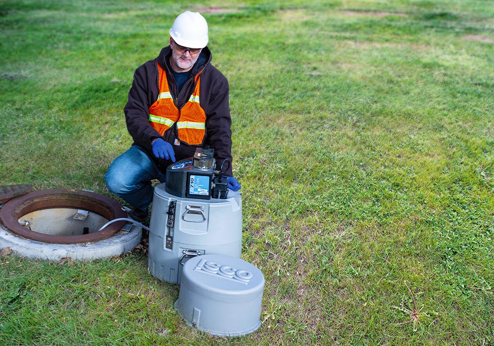 Portable automated sampler is being programmed to collect wastewater samples